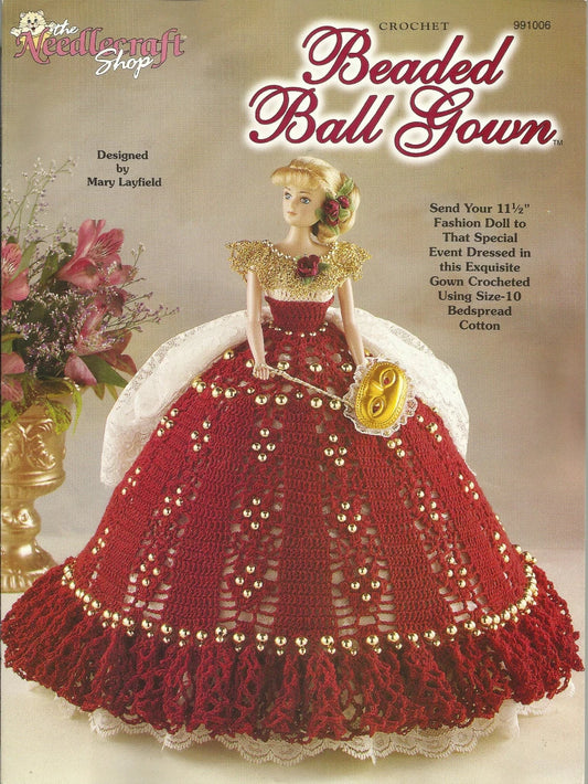 Crocheted beaded ball gown for a fashion doll on a magazine cover with text and floral decorations.