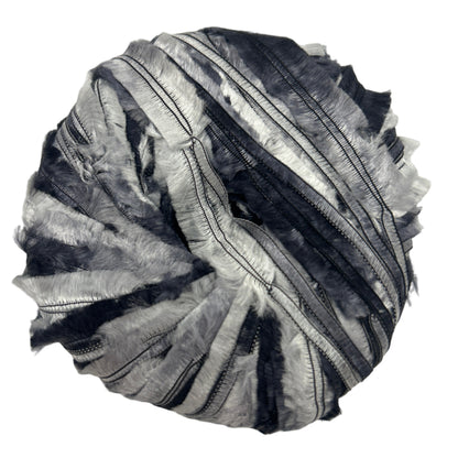 Black and silver striped fabric ball on a white background