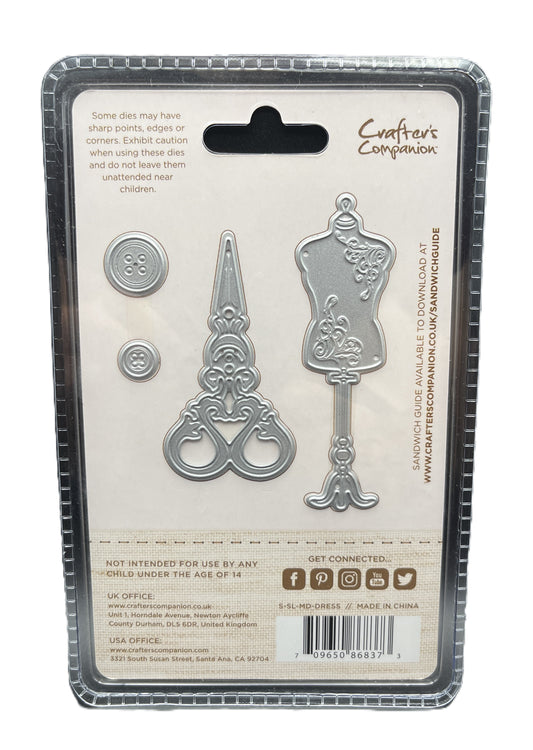 Metal die set packaging with decorative items on a white background