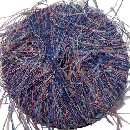 Coiled bundle of multicolored yarn on a white background