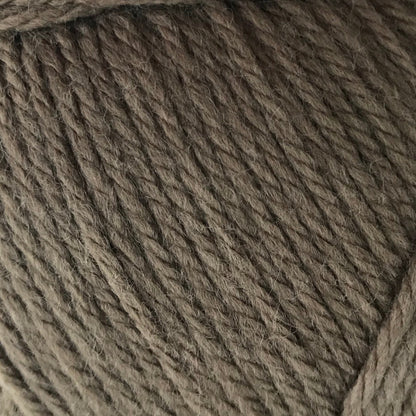 Ball of brown yarn on a white background