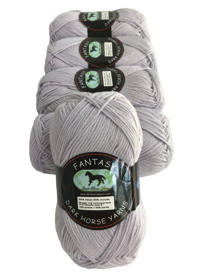 Three skeins of gray yarn with labels on a white background