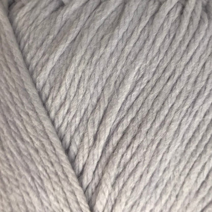 Ball of light gray yarn on a beige background
