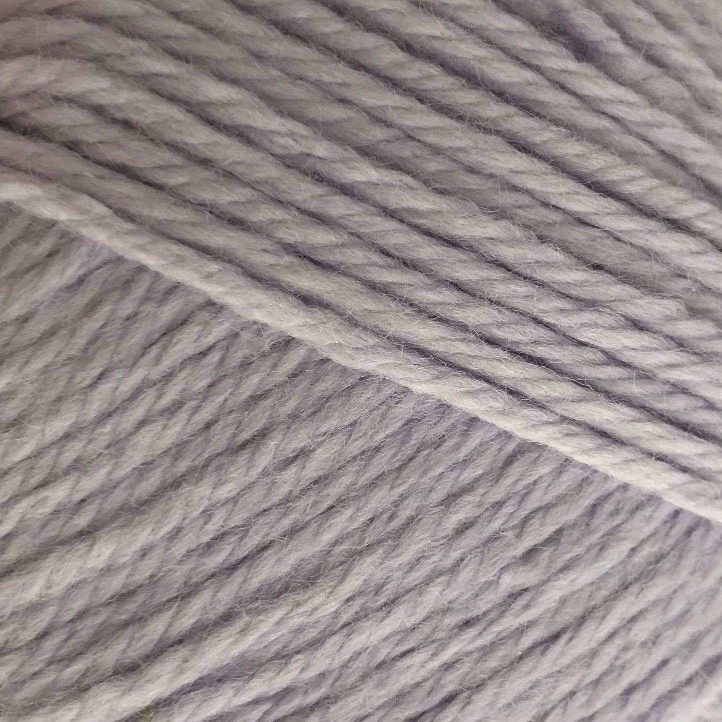 Gray skein of yarn with a label on a white background