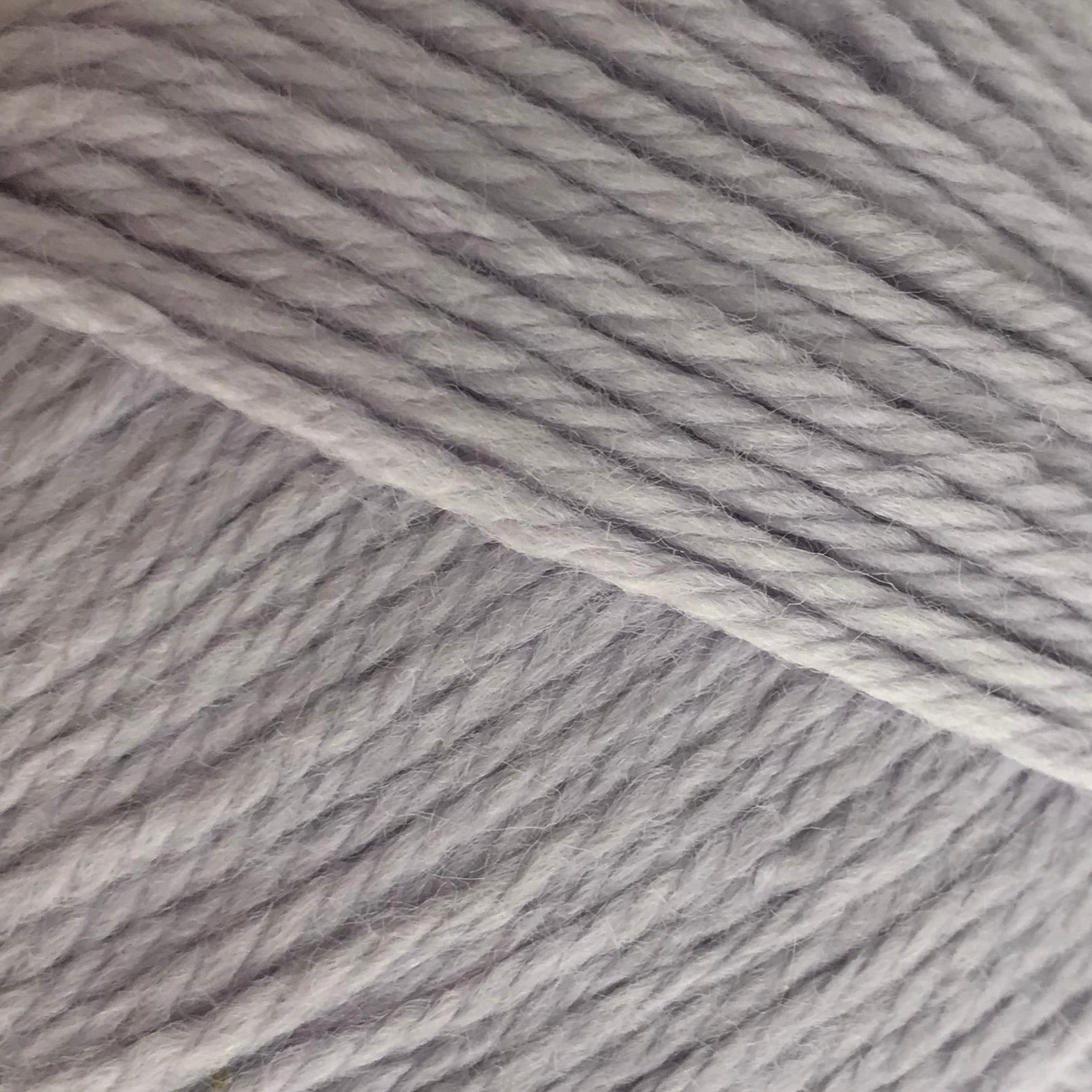 Gray skein of yarn with a label on a white background