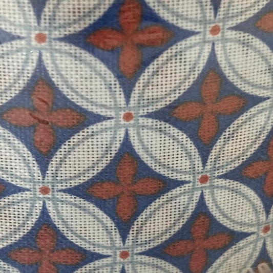 Patterned fabric with red floral shapes on a blue and white grid background