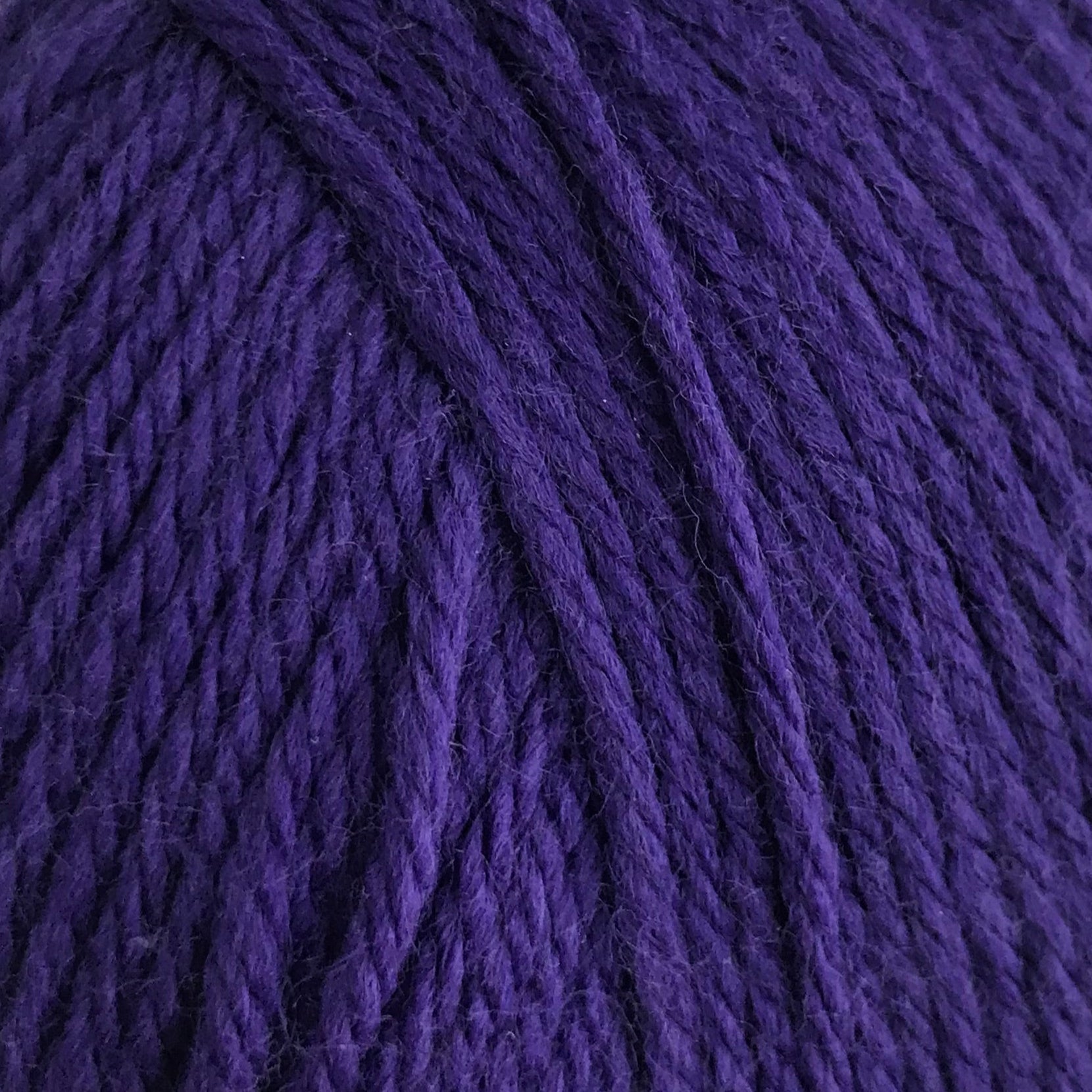 Purple yarn ball on a white background