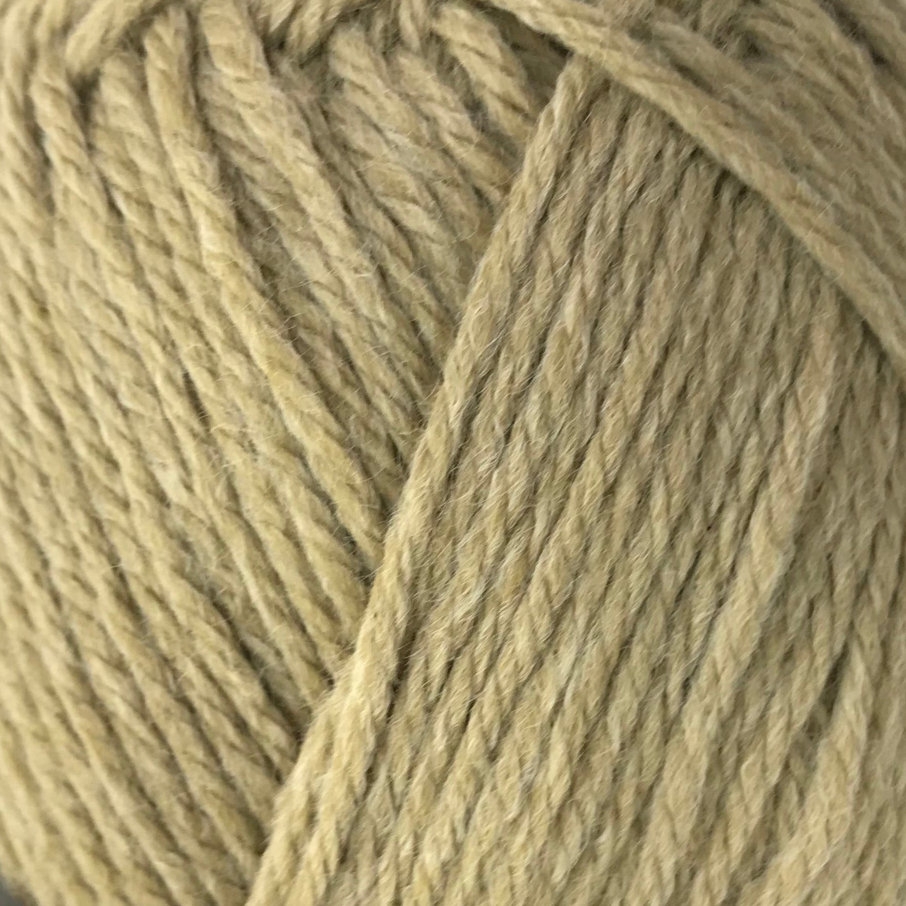 Ball of yarn with a black label on a white background