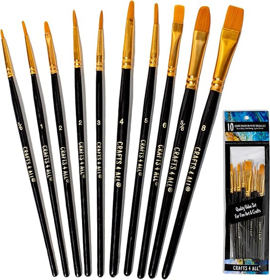 Set of black paintbrushes with gold ferrules and a packaging display on a white background.