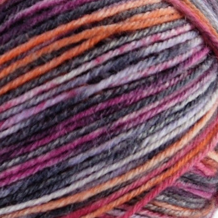 Close-up of a ball of multicolored yarn with shades of purple, orange, and gray.