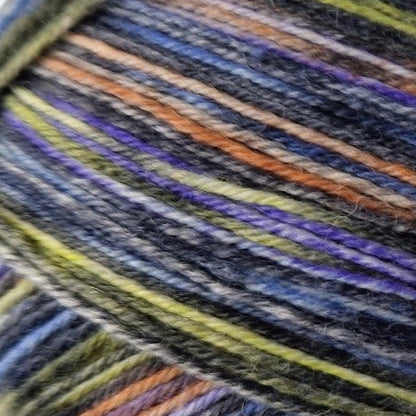Close-up of multicolored yarn with shades of blue, green, orange, and purple.