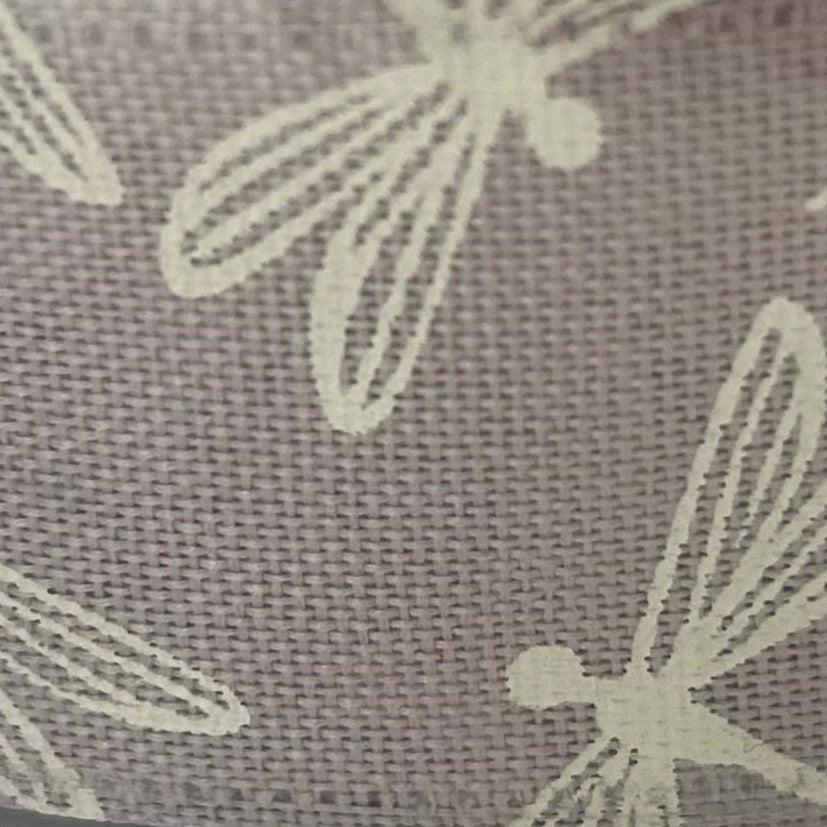 Close-up of a textured fabric with light-colored floral patterns on a dark background