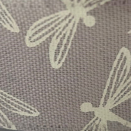 Close-up of a textured fabric with light-colored floral patterns on a dark background