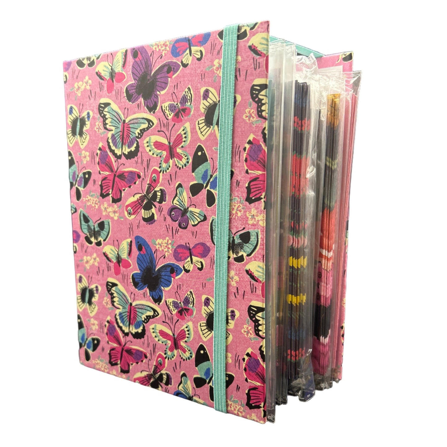 Stack of colorful butterfly-patterned notebooks on a dark surface