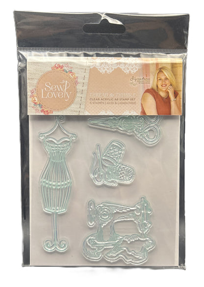 Clear acrylic stamp set with sewing-themed designs in a clear plastic packaging.