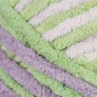 Close-up of textured fabric with green, white, and purple stripes.