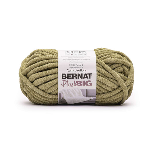 Ball of green yarn with Bernat Plush Big label on a white background