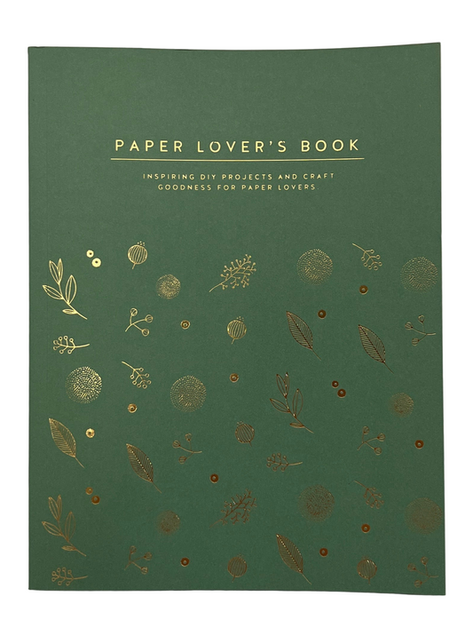 Green book titled 'Paper Lover's Book' with gold leaf patterns on a white background