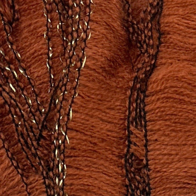 Close-up of brown fabric with embroidered pattern