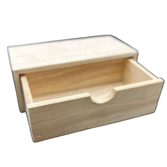 Wooden box with a circular indentation on a dark surface