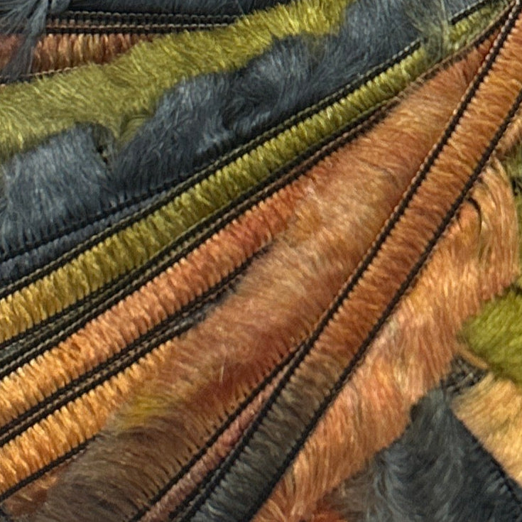 Close-up of textured fabric with brown, green, and black stripes.