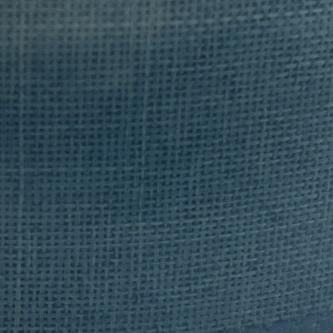 Close-up of a roll of blue fabric with a textured surface.