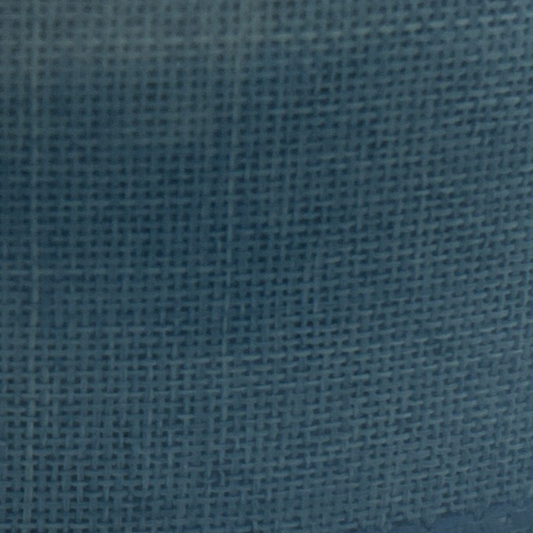 Close-up of a roll of blue fabric with a textured surface.