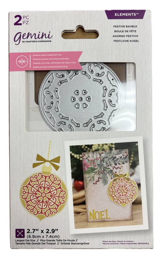 Packaged Gemini die set with decorative elements and a 'NOEL' card.