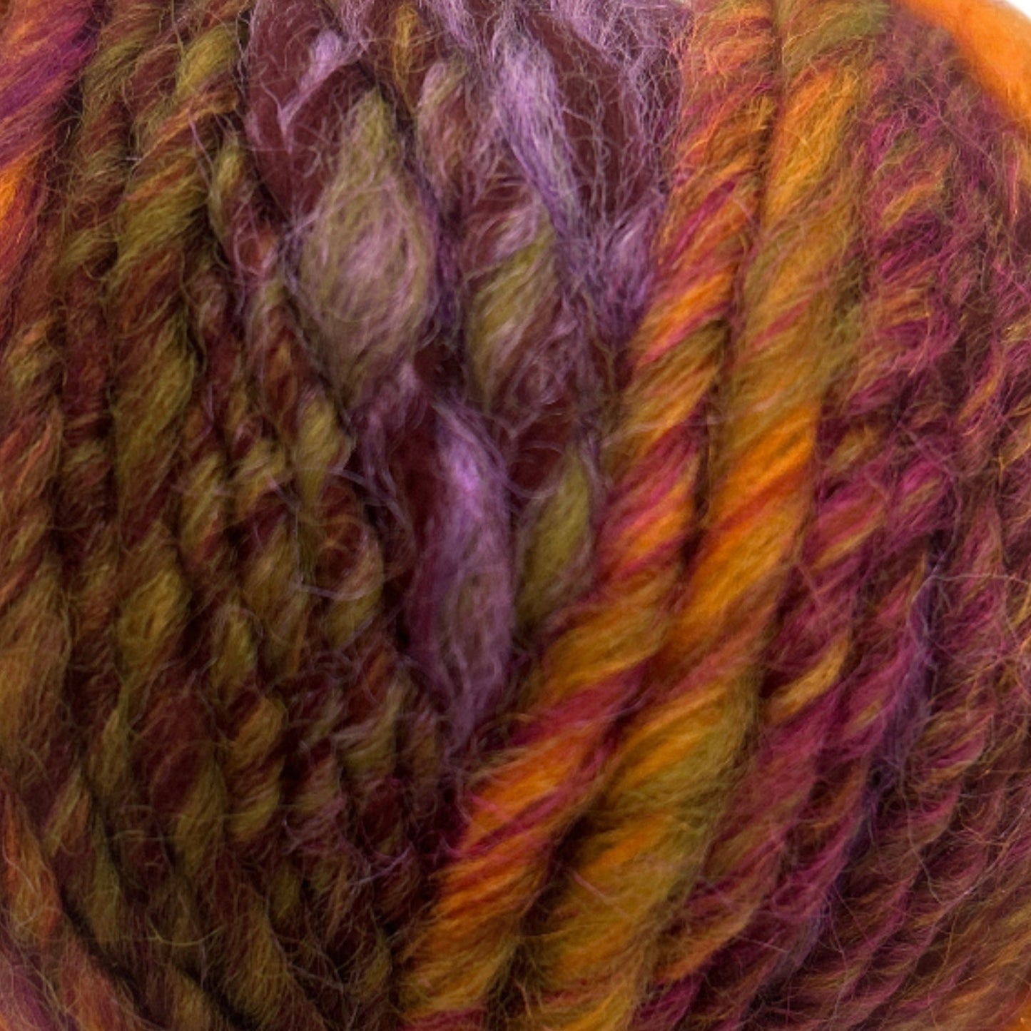 Multicolored skein of yarn with a visible brand label on a white background
