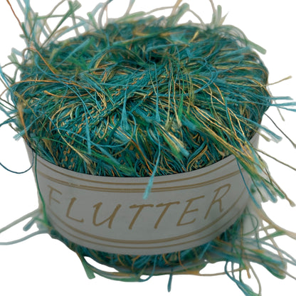 Ball of teal yarn with a label on a white background