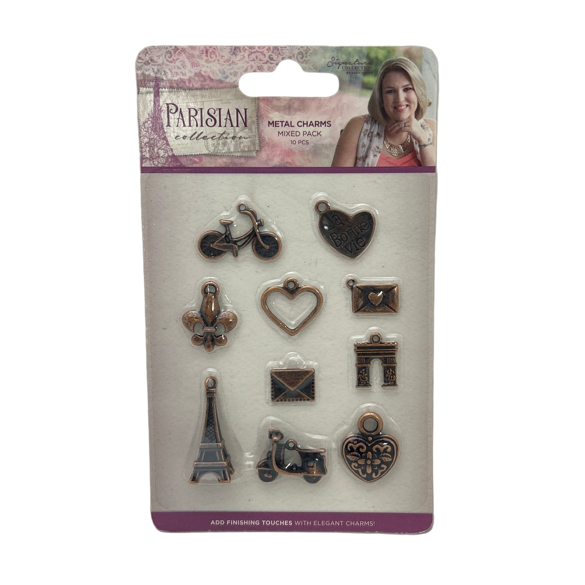 Packaging of metal charms with a person's face on the top left corner.