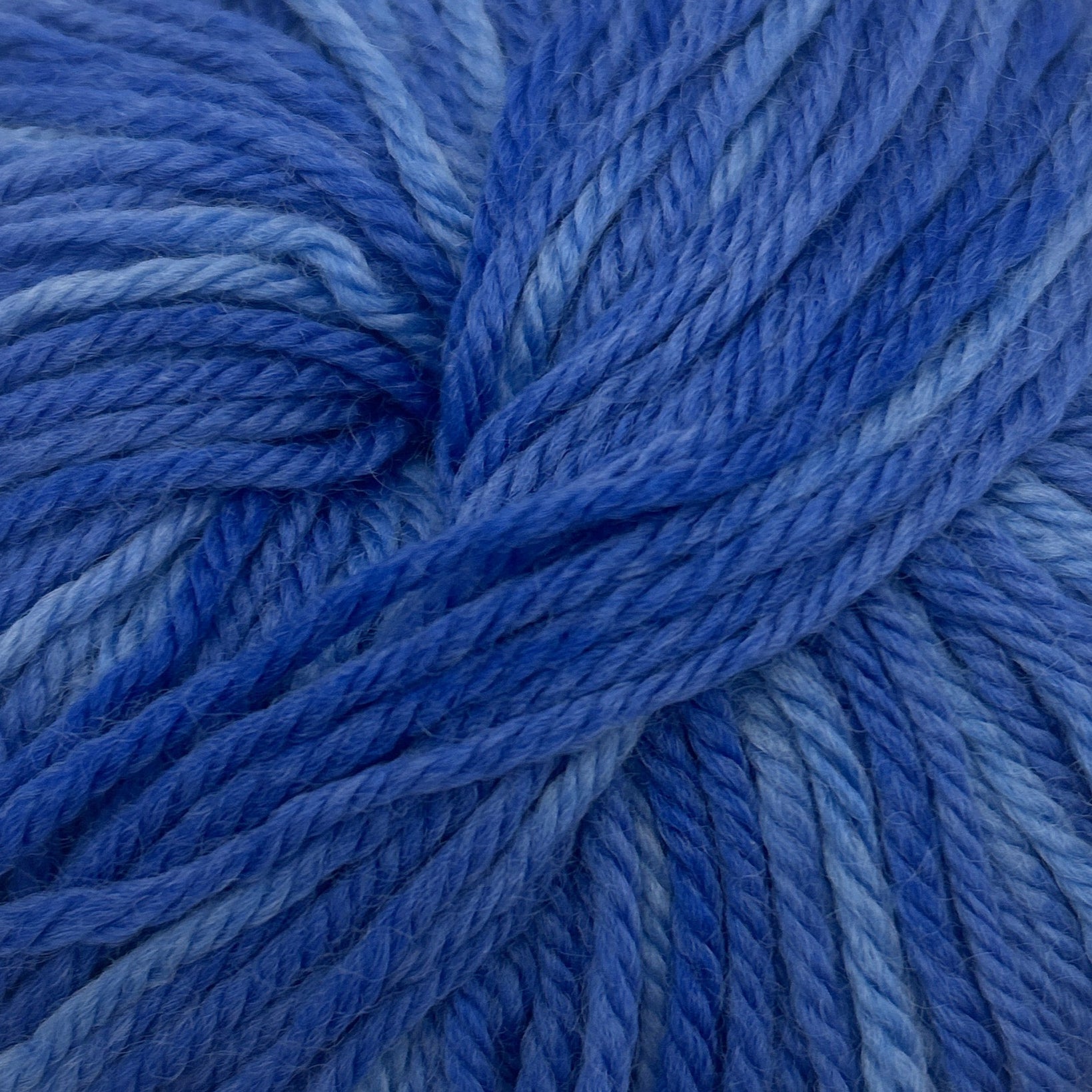 Blue skein of yarn on a white background