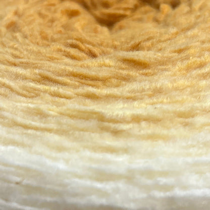 Roll of yarn with Caron label on a wooden surface