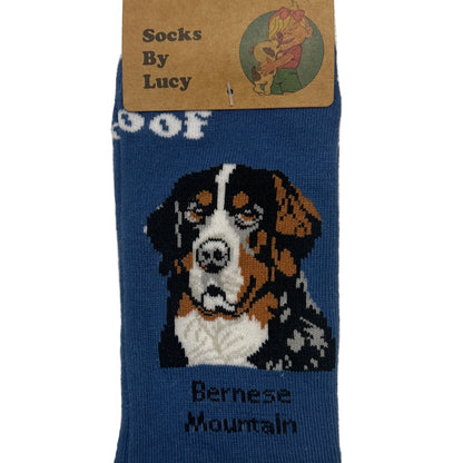 Blue sock with a dog design and brand label on a textured surface