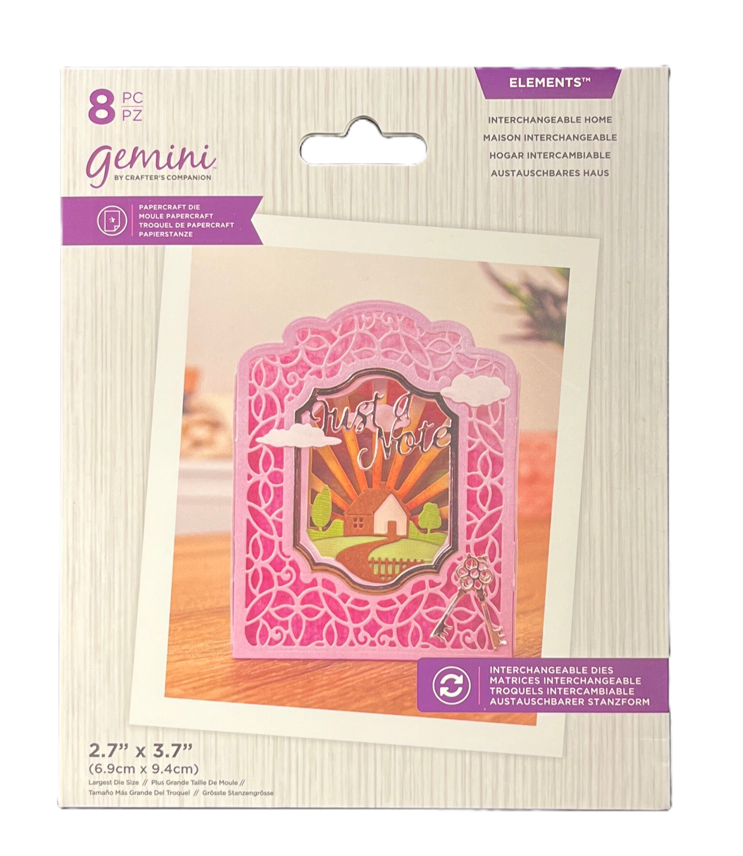 Packaging of Gemini interchangeable home decor elements with a pink design on a wooden surface.