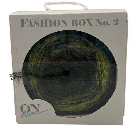 Fashion box with a green skein of yarn on a white background