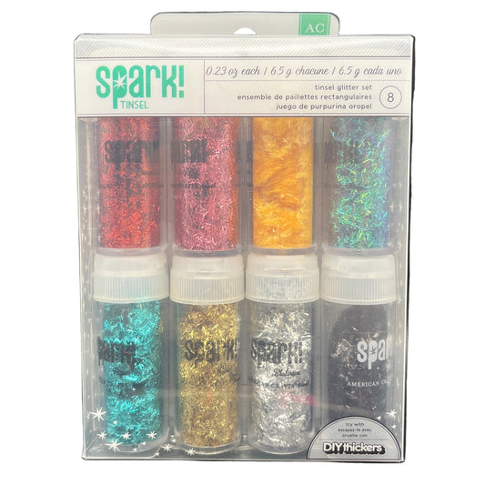 Packaged set of glitter bottles with 'Spark!' branding on a white background