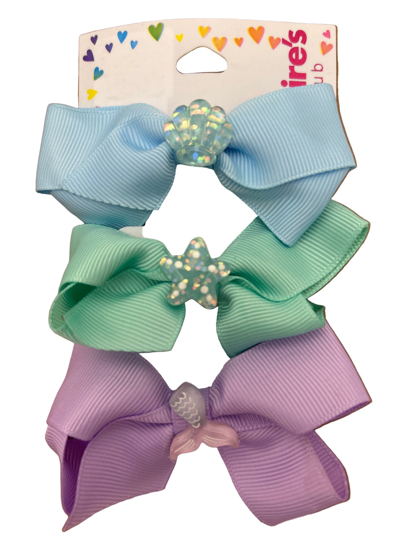 Three colorful hair bows on a cardboard backing with brand name visible