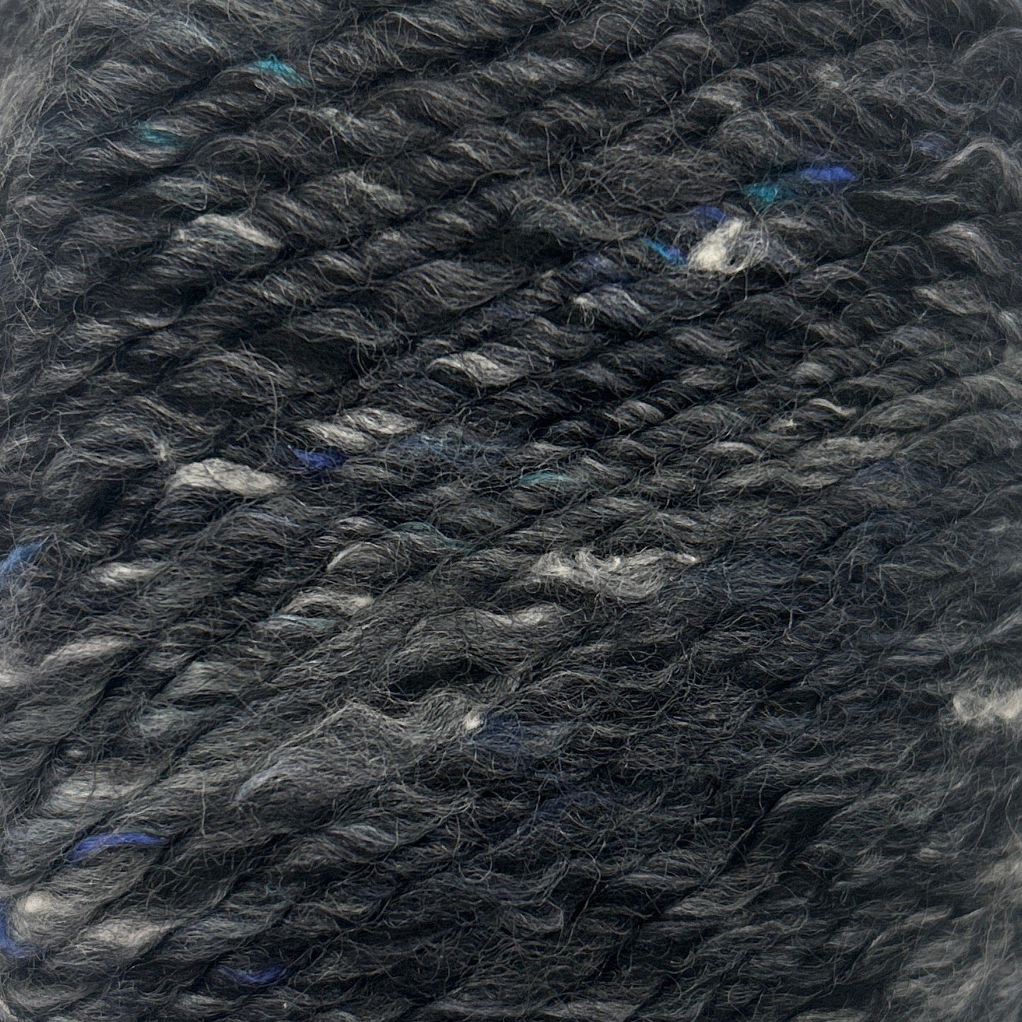 Ball of gray yarn on a white background