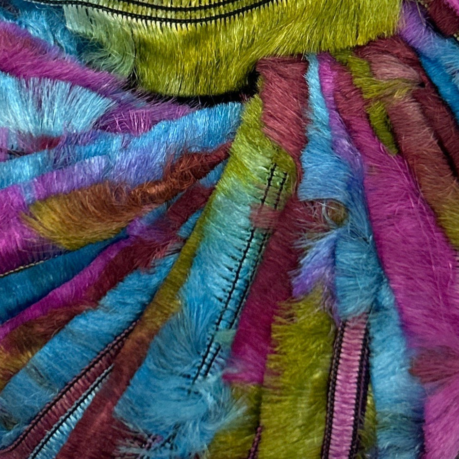 Close-up of colorful fabric with vibrant patterns and textures.