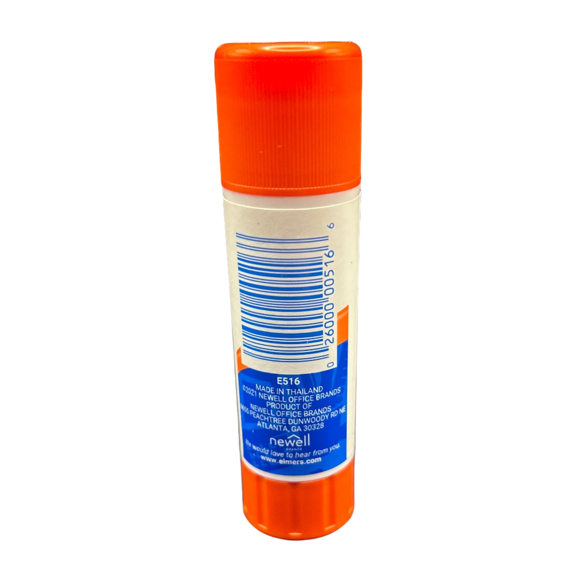 Glue stick with orange cap and blue label on a dark surface