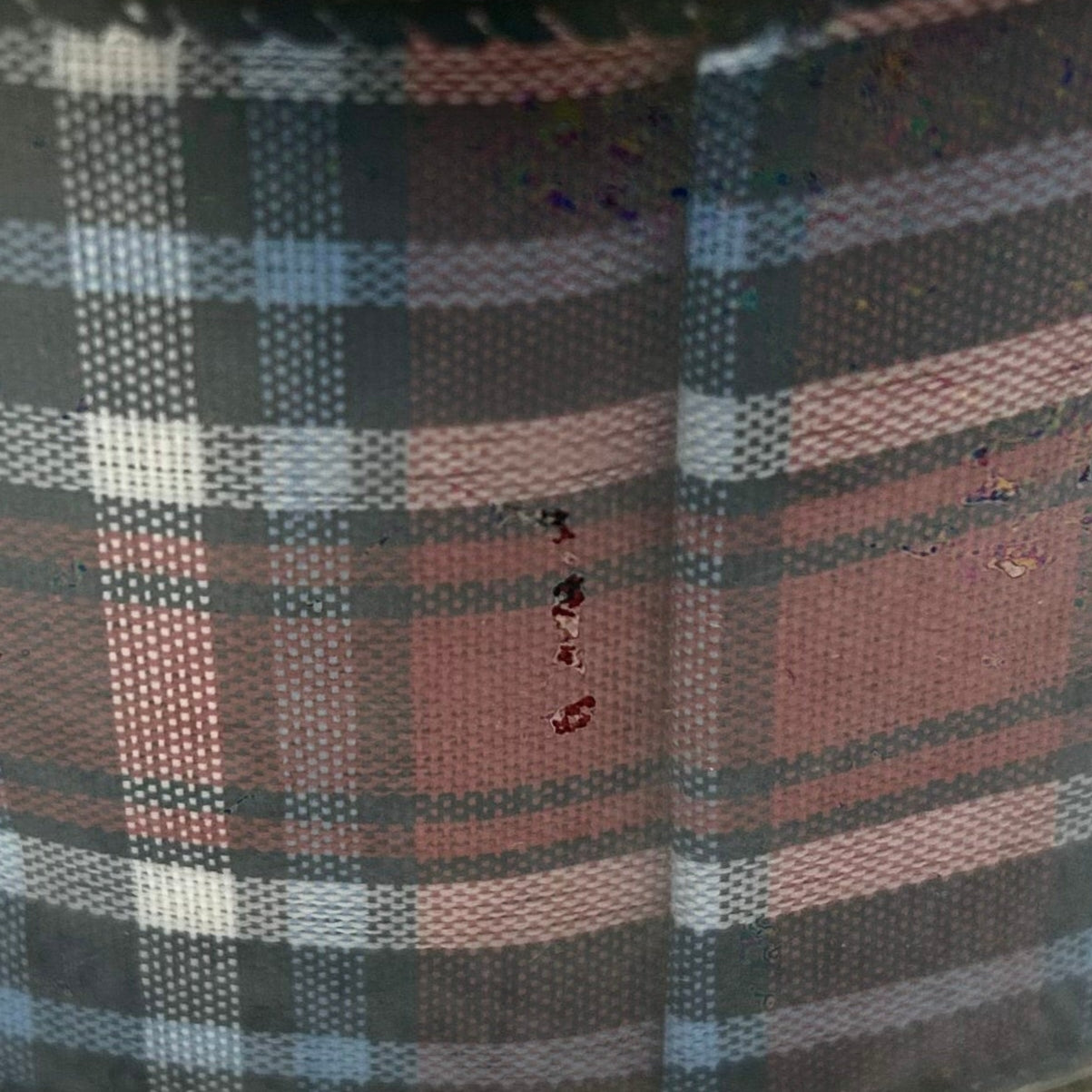 Close-up of plaid fabric with a focus on texture and pattern.