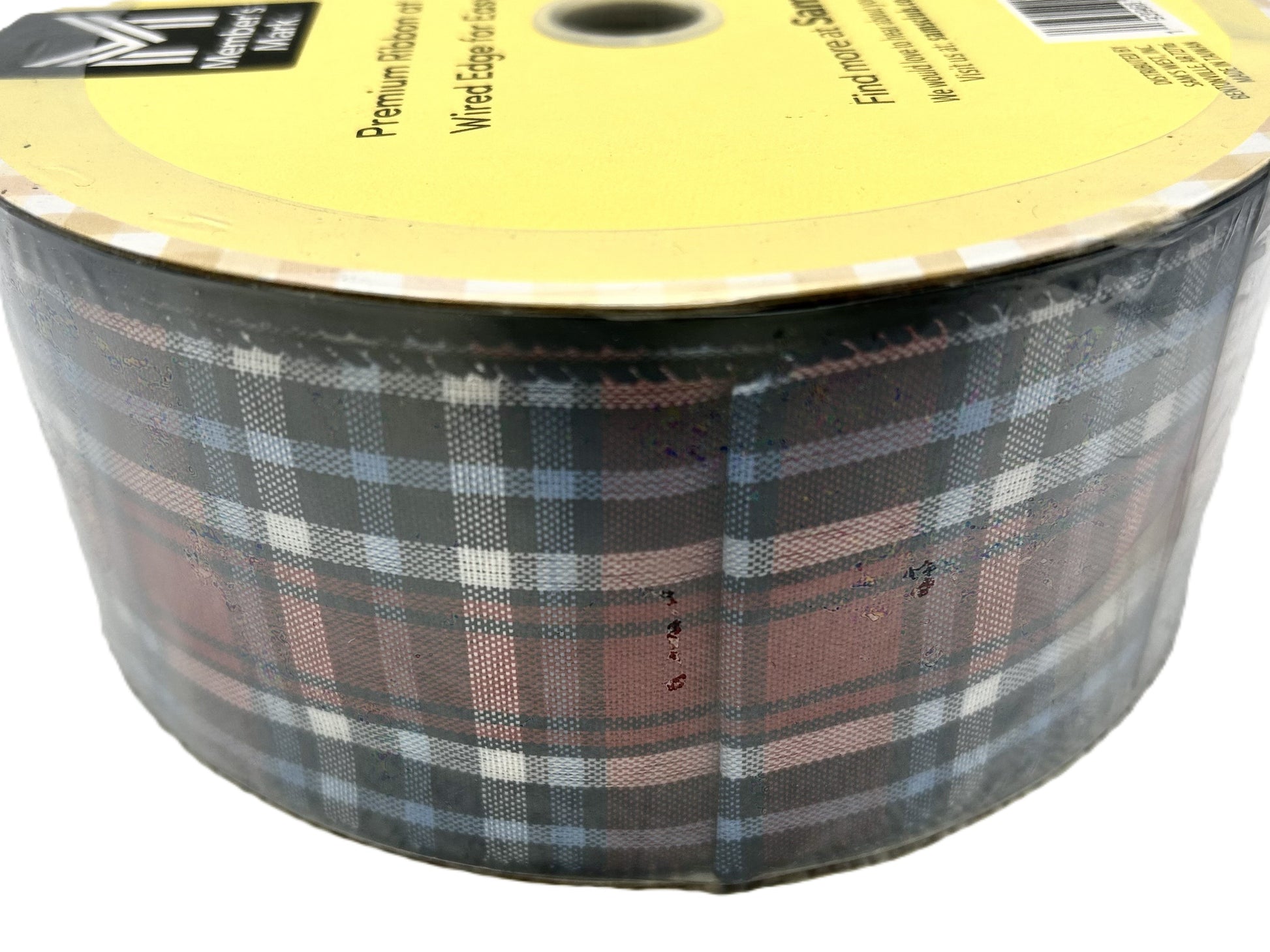 Plaid ribbon on a spool with a yellow label
