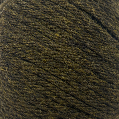 Ball of dark green yarn on a white background