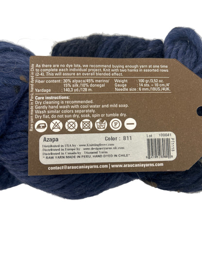 Navy yarn skein with a label on a white background