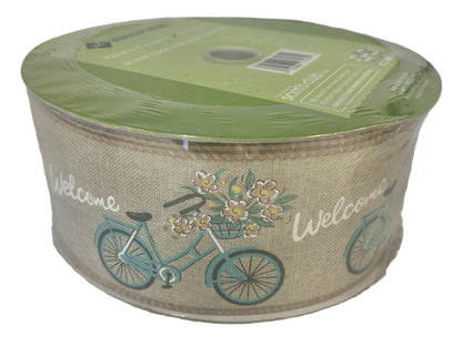 Roll of decorative ribbon with bicycle and flower design on a white background