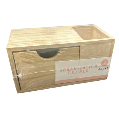 Wooden organization drawer with a label on a dark background