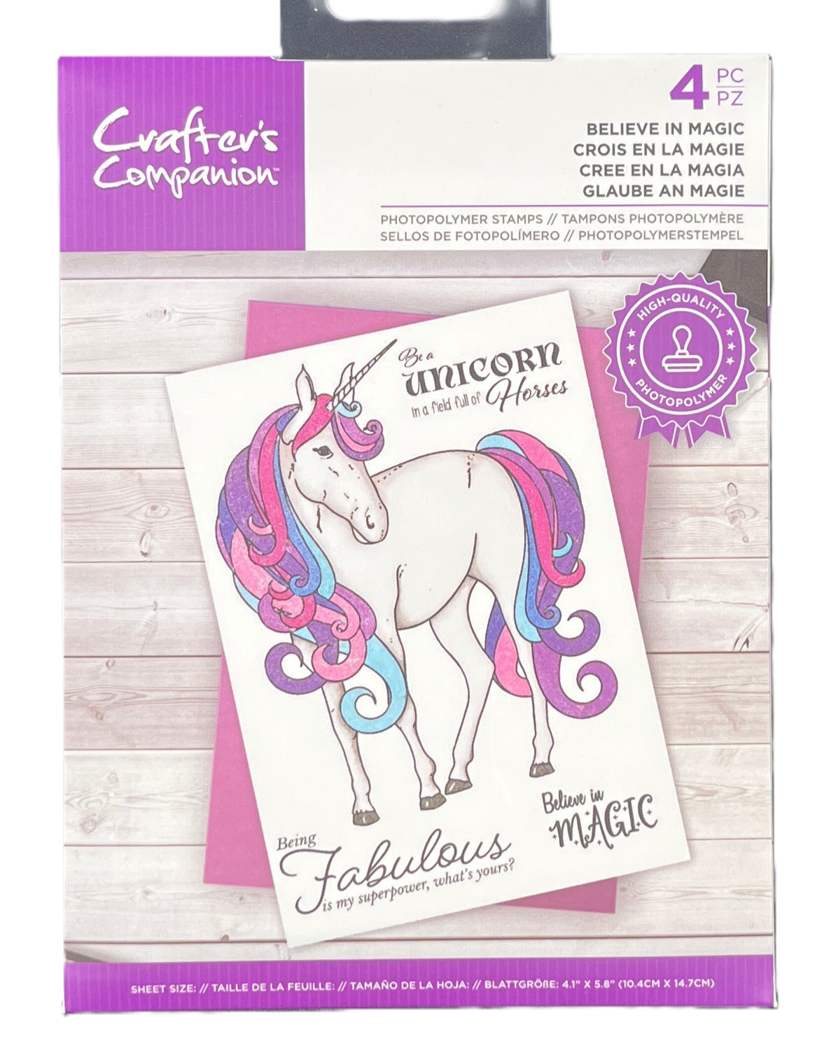Packaging of Crafter's Companion unicorn-themed stamps on a wooden surface