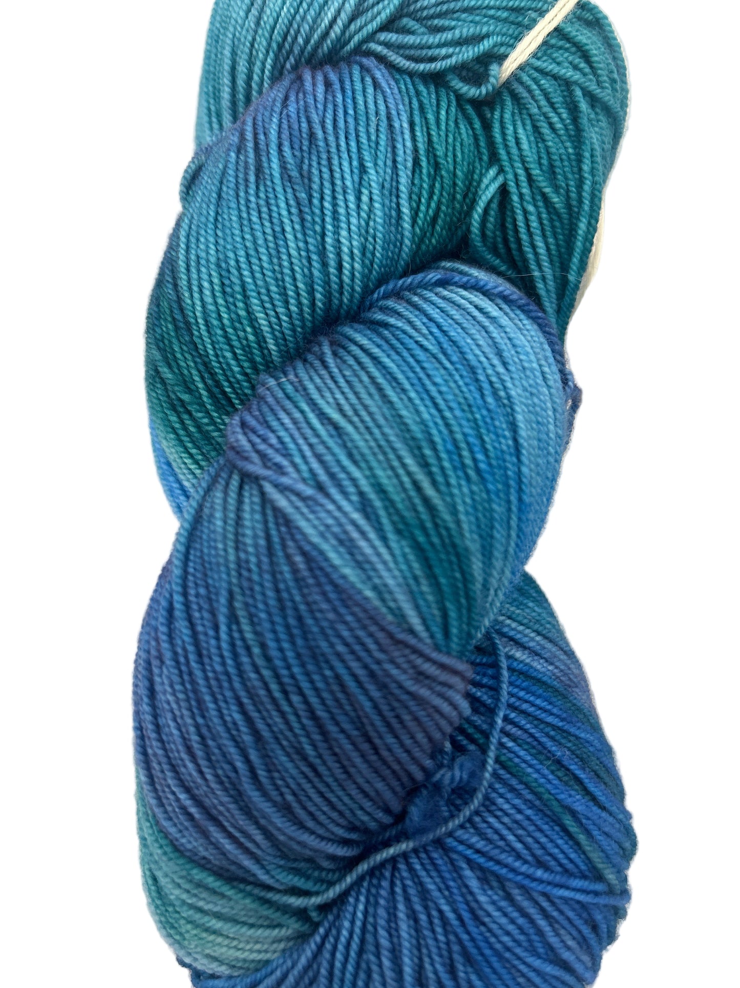 Blue skein of yarn with a brand label in the background