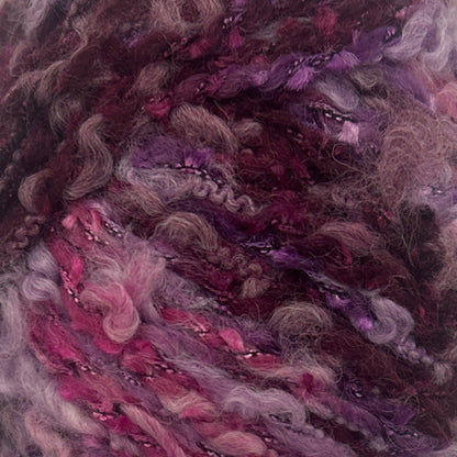 Close-up of multicolored yarn with shades of pink, purple, and brown.